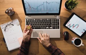 Expert,Man,Working,While,Bitcoin,Is,Standing,On,The,Table.
