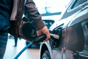 Human,Hand,Is,Holding,Electric,Car,Charging,Connect,To,Electric
